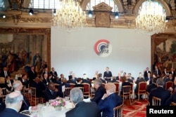 French President Emmanuel Macron delivers a speech before a lunch at the Elysee Palace, during commemorations for Armistice Day, 100 years after the end of World War One, in Paris, France, Nov. 11, 2018.