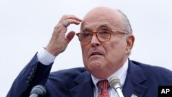 FILE - Rudy Giuliani, as an attorney for President Donald Trump, addresses a gathering during a campaign event in Portsmouth, N.H., Aug. 1, 2018. 