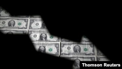 FILE PHOTO: Dollar banknotes are seen through printed stock graph in this illustration