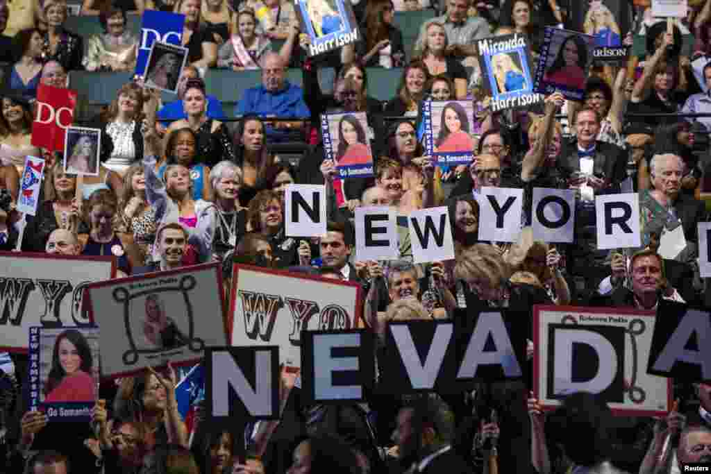 Members of the crowd hold up signs cheering on contestants during the 2014 Miss America Pageant in Atlantic City, N.J., Sept. 15, 2013.