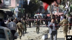 Security forces inspect the site of a suicide attack outside a Shi'ite mosque in Kabul, Afghanistan, Sept. 29, 2017.
