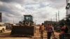 In this August 2020 photo, construction workers are seen at Ngong Road, a major road linking Nairobi to Ngong town that has been contracted to Quinjian International Group. The project is currently 95% finished. (Kang-Chun Cheng/VOA)