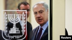 FILE - Israeli Prime Minister Benjamin Netanyahu is seen through a glass door in Jerusalem Oct. 7, 2013. 