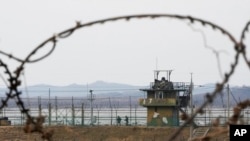 FILE - South Korean soldiers patrol along the barbed-wire fence in Paju, South Korea, near the border with North Korea, on Jan. 5, 2022.