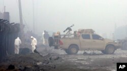 FILE - Security forces inspect the site of a suicide bomb attack in Kabul, Afghanistan, Nov. 29, 2018.