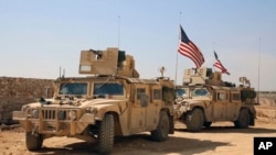 This March 7, 2017, frame grab from video provided by Arab 24 network, shows U.S. forces take up positions on the outskirts of the Syrian town, Manbij, a flashpoint between Turkish troops and allied Syrian fighters and U.S.-backed Kurdish fighters, in al-Asaliyah village, Aleppo province, Syria.