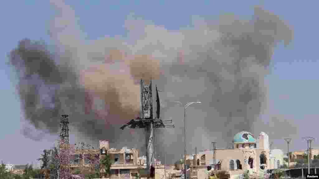 Smoke rises after what activists said was an airstrike by forces loyal to Syria's President Bashar al-Assad in Blleramoon district at the northern entrance to the city of Aleppo, March 23, 2014.