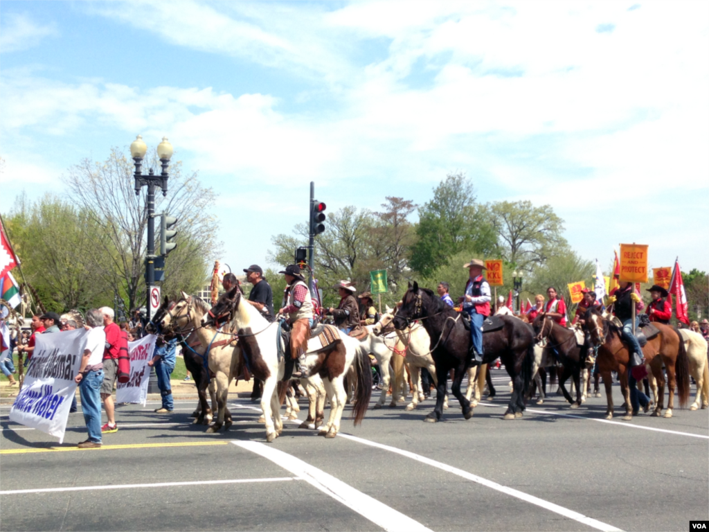 The Cowboy and Indian Alliance, a coalition of Native American tribes, ranchers, and farmers, stages a "Reject and Protect" protest against the Keystone XL oil pipeline project outside Capitol Hill, Washington D.C., April 22, 2014. (Diaa Bekheet/VOA)