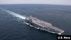 FILE - The Nimitz-class aircraft carrier USS Abraham Lincoln transits the Atlantic Ocean during a strait transit exercise, Jan. 30, 2019.