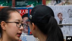 兩名女子在一處北京報攤前聊天 (資料圖片)
