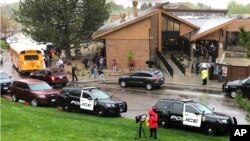 Police and others are seen outside a recreation center where students are reunited with their parents, in the Denver suburb of Highlands Ranch, Colo., after a shooting at STEM School Highlands Ranch, May 8, 2019.