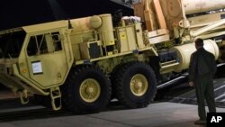 FILE - U.S. Forces Korea, a truck carrying parts of U.S. missile launchers and other equipment needed to set up the Terminal High Altitude Area Defense (THAAD) missile defense system arrive at Osan air base in Pyeongtaek, South Korea.
