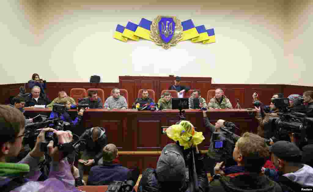 Leaders of pro-Russian protesters hold a news briefing inside the seized office of the SBU state security service in Luhansk, in eastern Ukraine, April 11, 2014.