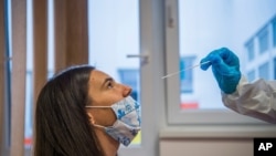 Seorang mahasiswa kedokteran mengambil sampel usap hidung di Budapest, Hongaria, 30 November 2020. (Foto: AP)