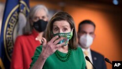 Speaker of the House Nancy Pelosi, D-Calif., meets with reporters before the House votes to pass a $1.9 trillion pandemic relief package, during a news conference at the Capitol in Washington, Friday, Feb. 26, 2021. Pelosi is flanked by Rep…
