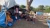 FILE - People look on at makeshift shelters near Awlala Camp, Amhara region, Ethiopia, May 31, 2024. UNICEF reported on Jan. 7, 2025, that 4.4 children in Amhara are unschooled due to disasters and violence. (Alfatih Alsemari via Reuters)