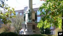 A student reads a book on campus, at Ohio University.