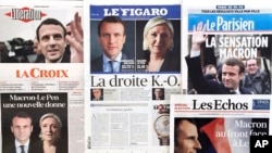 Copies of French national newspaper front pages reporting on the winners of the first round of the French presidential election, centrist candidate Emmanuel Macron and far-right candidate Marine Le Pen. French voters shut out the country's political mainstream from the presidency for the first time in the country's modern history, and on Monday found themselves being courted across the spectrum for the runoff election. (AP Photo/Laurent Rebours)