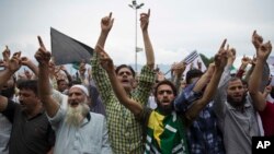 Kashmiri Muslims shout pro-freedom slogans during a demonstration after Friday prayers amid curfew-like restrictions in Srinagar, India, Aug. 16, 2019. 