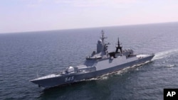 In this photo released Feb. 16, 2021, by the Iranian army, a Russian warship enters Iranian waters for a joint naval exercise with the Iranian navy and Iran's Revolutionary Guard navy.