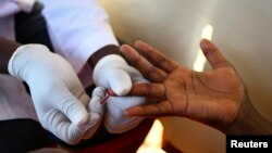 Seorang dokter mengambil darah seorang pria untuk memeriksa HIV/AIDS di unit pengujian lapangan di Ndeeba, pinggiran ibu kota Uganda, Kampala. (Foto: Reuters/Edwar Echwalu)