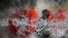 A security guard walks behind shattered glass at the CNN building at the CNN Center in the aftermath of a demonstration against police violence on May 30, 2020, in Atlanta.