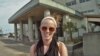 Kate O'Berg in front of one of the schools in Japan where she now teaches.(T.Banse/VOA)
