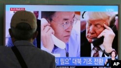 A man watches a TV screen showing U.S. President Donald Trump, right, and South Korean President Moon Jae-in during a news program at the Seoul Railway Station in South Korea, Sept. 5, 2017.