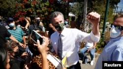 California Gov. Gavin Newsom takes photos with supporters after speaking at St. Mary's Center during a Stop the Recall rally ahead of the Republican-led recall election, in Oakland, Calif., Sept. 11, 2021.