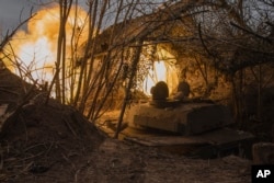 A Ukrainian self-propelled artillery vehicle Gvozdika fires toward Russian positions on the frontline in the Donetsk region, Ukraine, Feb. 16, 2024.