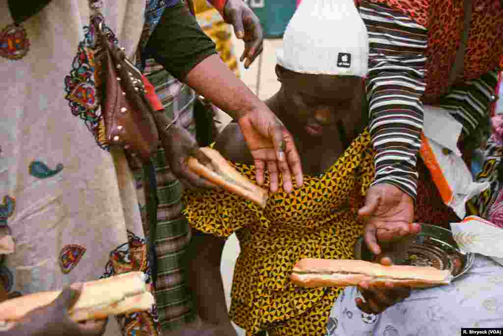 Women make sandwiches to hand out as the sun sets on another day of Ramadan fasting in Dakar, Senegal.