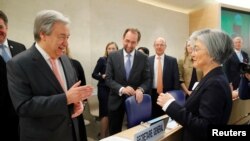 U.N. Secretary-General Antonio Guterres greets Kang Kyung-wha, South Korea's foreign minister, at the Human Rights Council at the United Nations in Geneva, Switzerland, Feb. 26, 2018. 