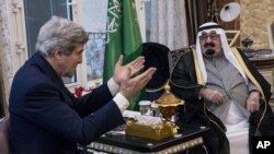 FILE - U.S. Secretary of State John Kerry, left, speaks with Saudi Arabia's King Abdullah before their meeting in Rawdat Khurayim, a secluded royal hunting retreat in Saudi Arabia, Jan. 5, 2014. 
