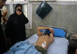 A man with pellet injuries lies in a hospital bed after he was injured during clashes between the Indian police and protesters in Srinagar Aug. 9, 2019.