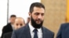 FILE - Syria's de facto leader Ahmad al-Sharaa walks in the presidential palace ahead of a meeting, in Damascus, Dec. 28, 2024.