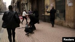 Activist Shaimaa Sabbagh is shown collapsed on the ground after she was shot during a protest in Cairo January 24, 2015.