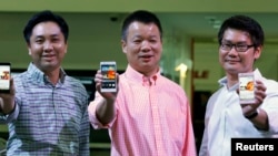 Huawei's Singapore CEO Zhou Bin (L-R), David Wei, President of Huawei South Pacific and Lim Chee Siong Chief Marketing Officer, Huawei South Pacific, show the new Huawei Ascend P6 Android-based smartphones during their launch at CommunicAsia communication
