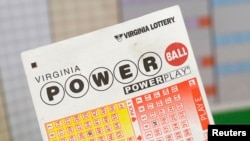 A man holds the tickets he purchased for Virginia's $400 million Powerball lottery in Arlington, Virginia February 19, 2014.