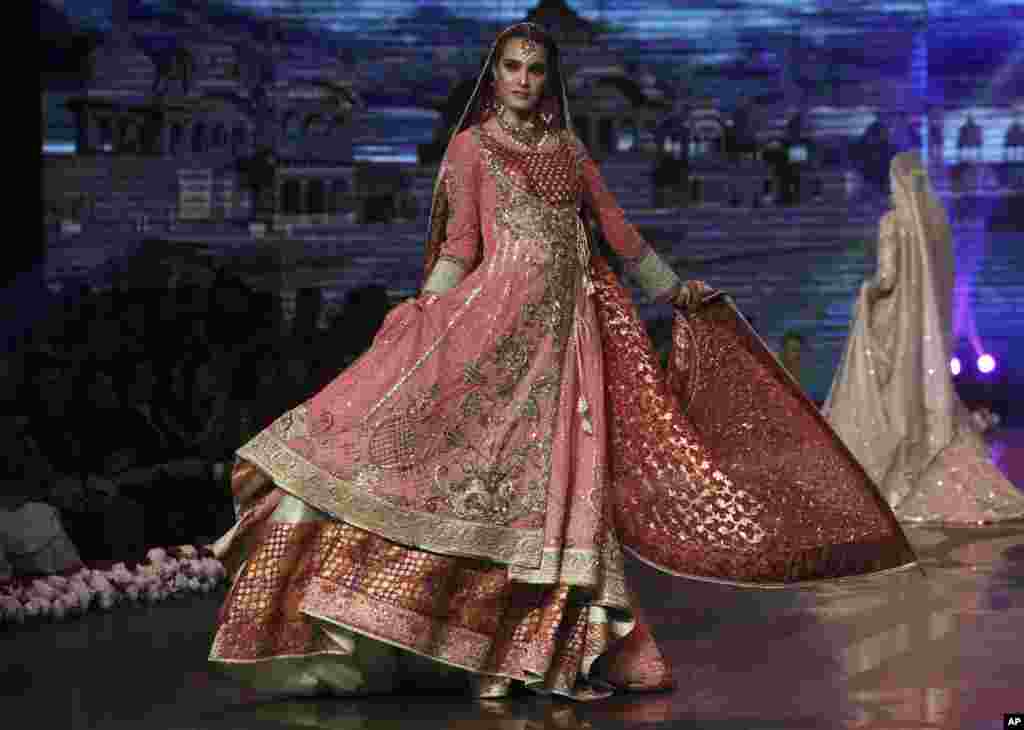 Seorang model Pakistan mengenakan koleksi baju pengantin pada pameran busana di Lahore.