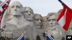 FILE - Flags frame the presidents on the Mount Rushmore monument, Dec. 9, 2016, near Keystone, S.D.