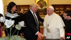 Papa Franja razmenjuje poklone sa predsednikom SAD Donaldom Trampom i prvom damom Melanijom Tramp tokom prijema u Vatikanu, 24. maja 2017. (AP Photo/Alessandra Tarantino, Pool)