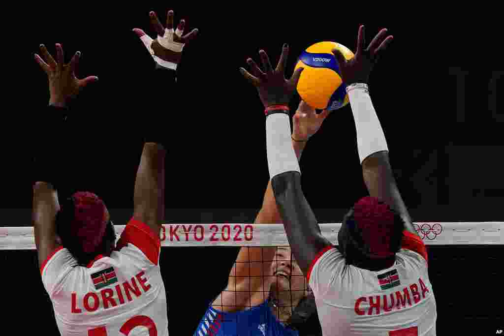 Kenya's Lorine Chebet Kaei, left, Kenya's Sharon Chepchumba Kiprono, right, and Serbia's Bojana Milenkovic challenge for the ball during the women's volleyball preliminary round pool A match between Serbia and Kenya at the 2020 Summer Olympics, Thursday, July 29, 2021, in Tokyo, Japan. (AP Photo/Frank Augstein)