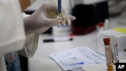 FILE - A blood samples from pregnant women are analyzed for the presence of the Zika virus, Feb. 2, 2016. 