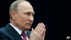 Russian President Vladimir Putin gestures speaking to the media after his annual live call-in show in Moscow, Russia, June 15, 2017. 
