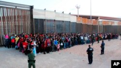FILE - The U.S. Customs and Border Protection shows some of 1,036 migrants who crossed the U.S.-Mexico border in El Paso, Texas, the largest that the Border Patrol says it has ever encountered, May 29, 2019.