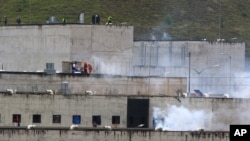 FILE - Tear gas rises from parts of the Turi prison where an inmate riot had broken out in Cuenca, Ecuador, Feb. 23, 2021. Inmates at Turi are holding more than 50 people hostage, the country's interior minister said Aug. 31, 2023, in a protest over prisoner transfers.