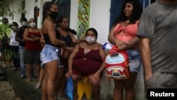 Members of the community Quilombo Quilomba, descendants of African slaves, wait to receive shots of Sinovac's CoronaVac vaccine, in Mage, Rio de Janeiro state, Brazil, April 7, 2021.