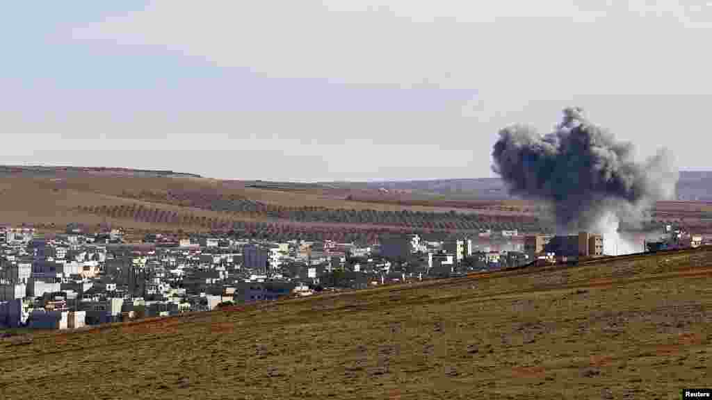 Smoke rises from the Syrian town of Kobani, seen from near the Mursitpinar border crossing on the Turkish-Syrian border in the southeastern town of Suruc, Sanliurfa province, Oct. 20, 2014.