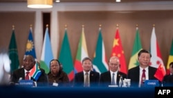 President of China Xi Jinping (R) and South African President Cyril Ramaphosa (L) attend the China-Africa Leaders' Roundtable Dialogue on the last day of the 2023 BRICS Summit in Johannesburg on August 24, 2023. (Photo by ALET PRETORIUS / POOL / AFP)