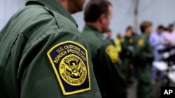 FILE - U.S. Customs and Border Protection agents hold a news conference in Donna, Texas, May 2, 2019.